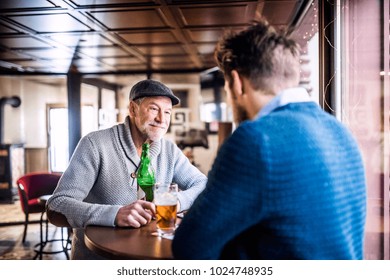 Senior father and his young son in a pub.