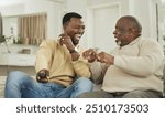 Senior father, son and remote on sofa with laughing for funny football match, esports or bonding in home. Happy family, black people and relax on couch with watching television, talking or sport show