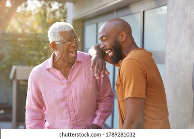 Senior Father Talking And Laughing With Adult Son In Garden At Home - Powered by Shutterstock