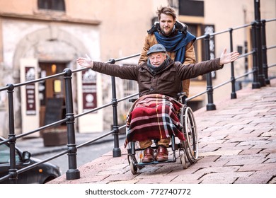 Senior father in wheelchair and young son on a walk. - Powered by Shutterstock