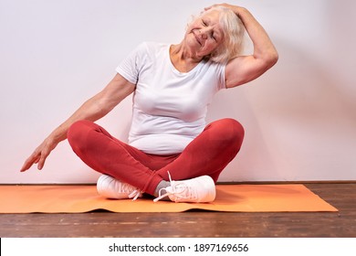 Senior Female 60 Years Old Sits Exercising, Recreation And Sport Concept, Wellbeing