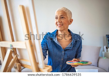Similar – Image, Stock Photo Elderly woman artist holding a paintbrush in a studio