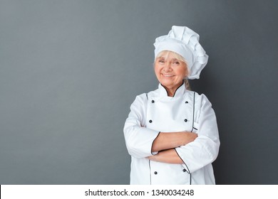 Senior Female Chef Studio Standing Isolated On Gray Wall Crossed Arms Looking Camera Smiling Confident