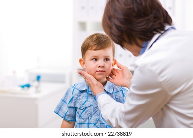 Senior Female Doctor Examining Little Child Boy.