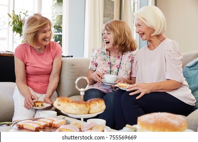 Senior Female Friends Enjoying Afternoon Tea At Home Together