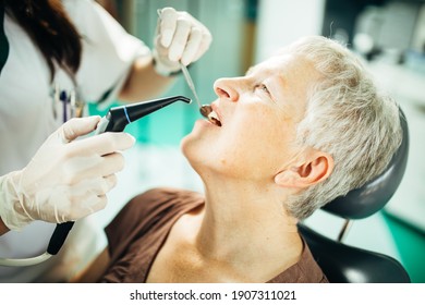 Senior Female Patient On A Dentist Appointment. Regular Check Up At Orthodontist. Specialist Examining A Older Patient. Dental Prosthetics Implant For Retired Pensioner Woman