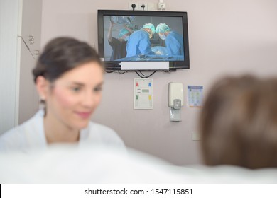 senior female patient watching tv in hospital bed