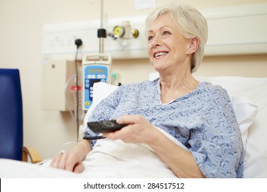 Senior Female Patient Watching TV In Hospital Bed