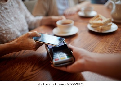 Senior female using modern gadget for contactless payment - Powered by Shutterstock