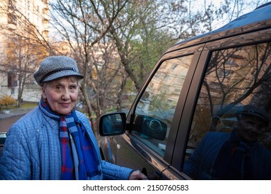 Senior Female Wearing Casual About To Open A Car Door, Outdoor Shot