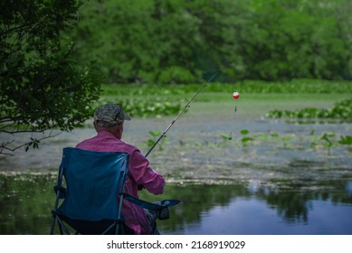 A senior fishing on the lake in the Summer 