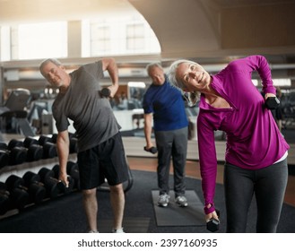 Senior fitness club, stretching and people with dumbbells at gym for training, wellness or exercise. Class, workout and elderly men with personal trainer for weightlifting, support or bodybuilding - Powered by Shutterstock