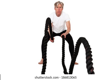 Senior fitness man exercising with black battling rope. Isolated on white.