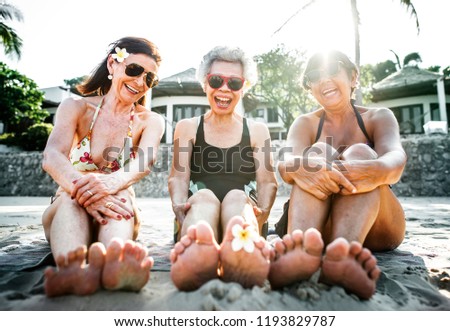 Senior friends enjoying the beach in the summertime