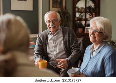 Senior friends enjoying coffee and conversation at home - Powered by Shutterstock