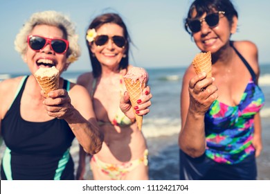 Senior friends having fun at the beach - Powered by Shutterstock