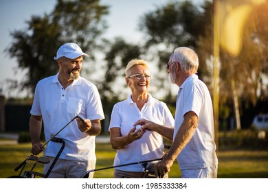 Senior friends on golf court talking.  - Powered by Shutterstock