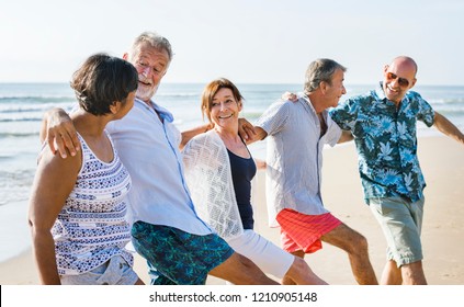 Senior Friends Playing At The Beach