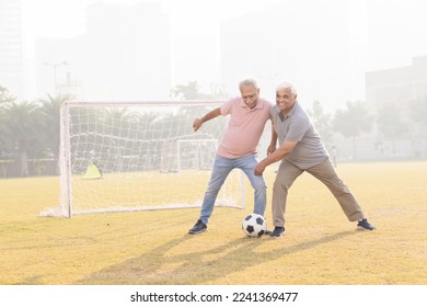 Senior friends playing football together. - Powered by Shutterstock