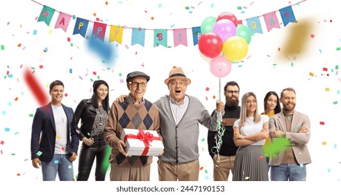 Senior friends with a present and balloons celebrating birthday with a group of young people isolated on white background - Powered by Shutterstock