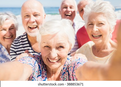 Senior friends taking selfie on the beach - Powered by Shutterstock