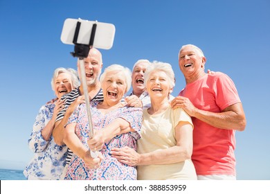 Senior friends taking selfie on the beach - Powered by Shutterstock