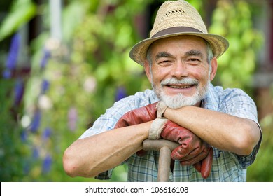 Senior gardener with a spade in the garden - Powered by Shutterstock