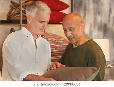 Senior Gay Male Couple Shopping For Home Accessories For Their Home