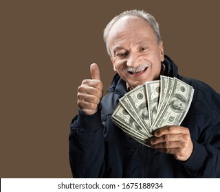 Senior Gentleman Holding A Stack Of Money. Portrait Of An Excited Old Man. Happy Old Man Holding Dollar Banknotes.