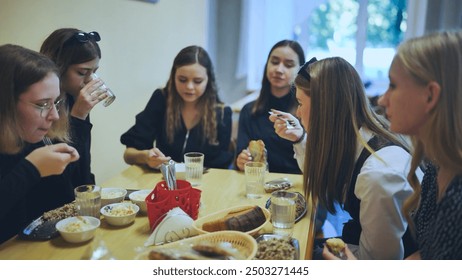 Senior girls having breakfast in the school canteen. - Powered by Shutterstock