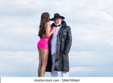 Senior glamour man and sexy young woman. Gangster look, Mafia pimp. Sexy lovers couple old and young. Dominant man. Mature dandy man with sexy girl. Submission