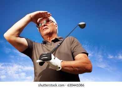 Senior Golfer With White Hair Posing