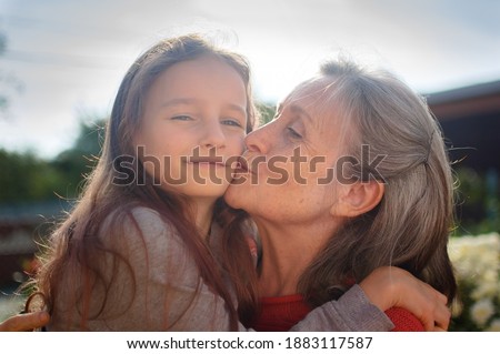 Similar – Granddaughter hugging her grandmother