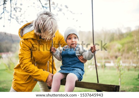 Similar – old swing on the playground on the street