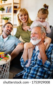 Senior Grandparents Playing With Grandchildren And Having Fun With Family