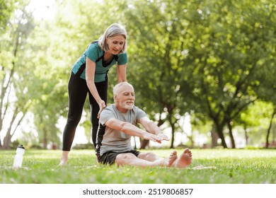 Senior, gray haired man doing stretching exercises with personal trainer in the park sport concept - Powered by Shutterstock