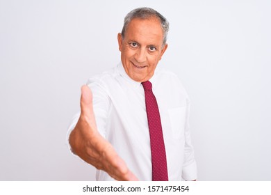 Senior Grey-haired Businessman Wearing Elegant Tie Over Isolated White Background Smiling Friendly Offering Handshake As Greeting And Welcoming. Successful Business.