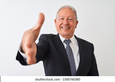 Senior Grey-haired Businessman Wearing Suit Standing Over Isolated White Background Smiling Friendly Offering Handshake As Greeting And Welcoming. Successful Business.