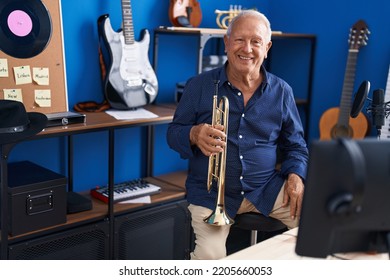 Senior Grey-haired Man Musician Holding Trumpet At Music Studio