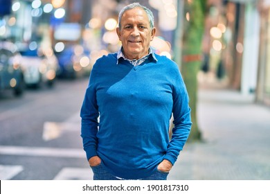 Senior grey-haired man smiling happy standing at the city.