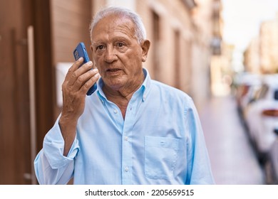 Senior grey-haired man talking on the smartphone at street - Powered by Shutterstock