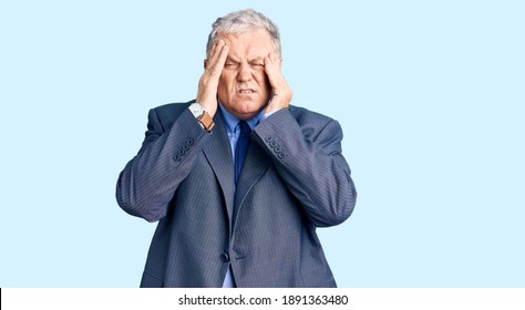 Senior grey-haired man wearing business jacket with hand on head, headache because stress. suffering migraine. 