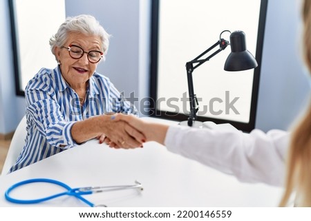 Similar – Female doctor filling out a questionnaire to senior patient