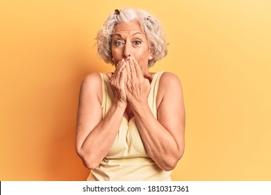 Senior Grey-haired Woman Wearing Casual Clothes Laughing And Embarrassed Giggle Covering Mouth With Hands, Gossip And Scandal Concept 