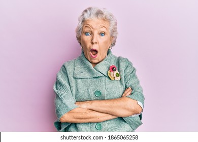 Senior Grey-haired Woman Wearing Casual Clothes Afraid And Shocked With Surprise And Amazed Expression, Fear And Excited Face. 