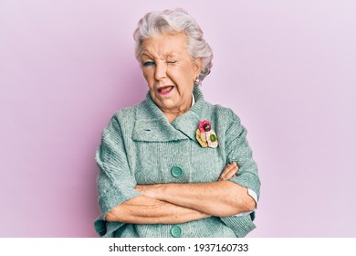 Senior grey-haired woman wearing casual clothes winking looking at the camera with sexy expression, cheerful and happy face. 