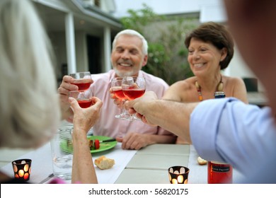 Senior Group Having A Toast During A Dinner On A Terrace