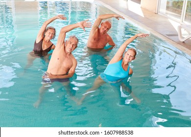 Senior Group In The Pool Doing Back Exercises In An Aqua Fitness Class