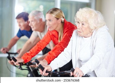 Senior Group Together In A Spinning Class In Rehab Care Center