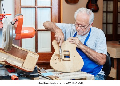 Senior guitar maker makes new guitar with care at luthier's wood workshop
